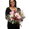 Sweet Candy bouquet of pink and red roses with eucalyptus, held by a florist
