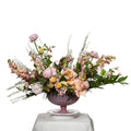 Kandi arrangement of peach roses, snapdragons and grasses in a mauve footed bowl