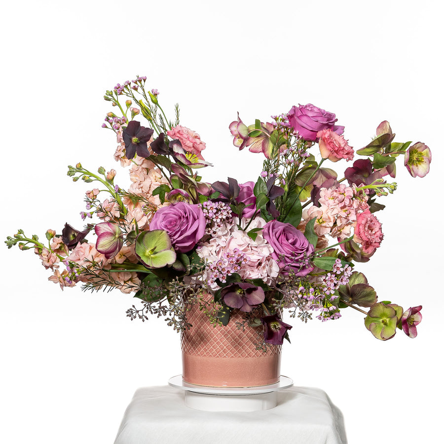 Fairy Garden arrangement of pink and lilac roses, carnations and sweet peas in a blush pot