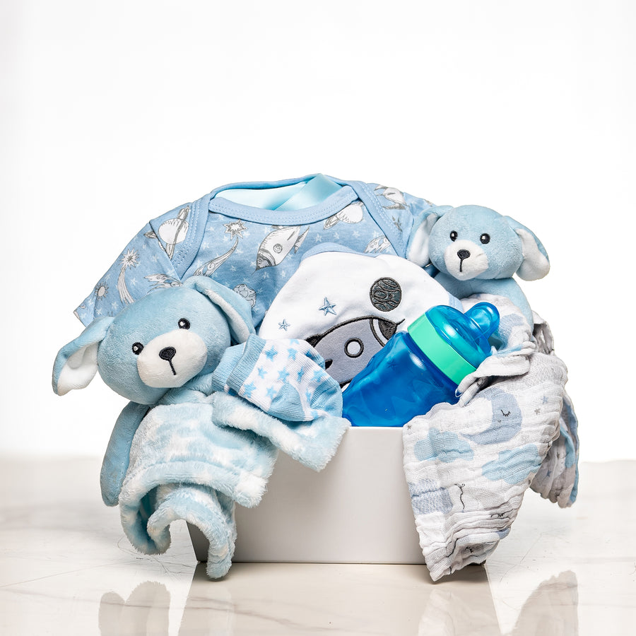 Everyday Essentials baby boy gift with blue sleepsuits, plush bunnies, a bib and a bottle