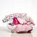 Everyday Essentials baby girl gift with pink sleepsuits, a bib, a bottle and a blanket