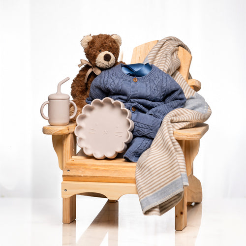 Muskoka Bear baby boy gift, a wooden chair with a teddy, a navy knitted set and a sippy cup