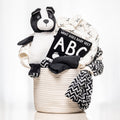 Curious by Contrast baby gift with a black and white plush dog, an ABC book and monochrome blankets