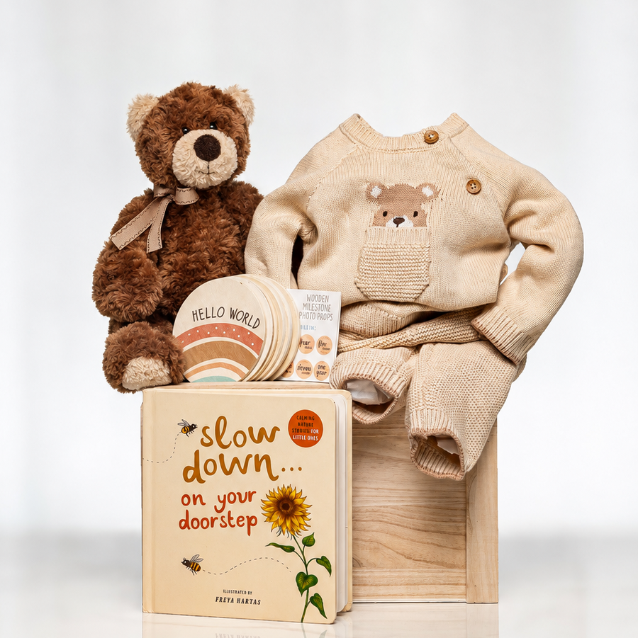 Bear Necessities baby gift with a brown plush teddy, a knitted bear sweater and a keepsake book
