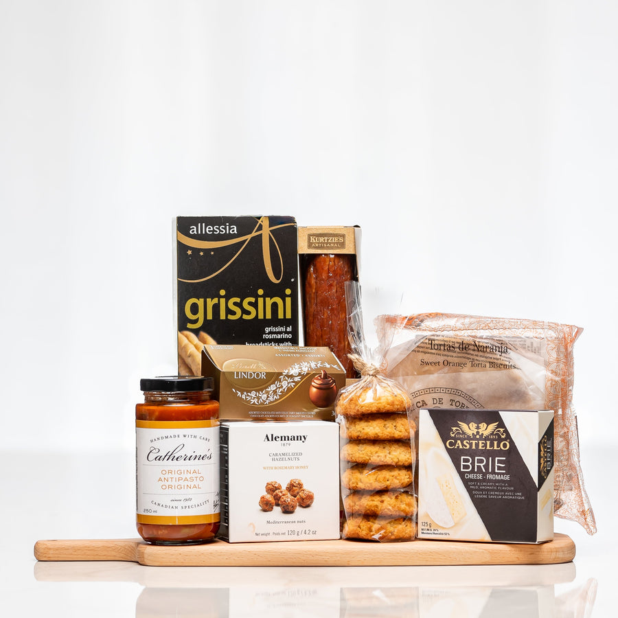 Bistro Board wooden serving board with grissini, sauce, brie, biscotti and gourmet snacks