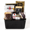 Bistro gift basket: a black metal mesh basket with Jakeman's buttermilk pancake mix, pure maple syrup, ground coffee, Castello brie, fig jam, baguette crisps and chocolate covered pretzels