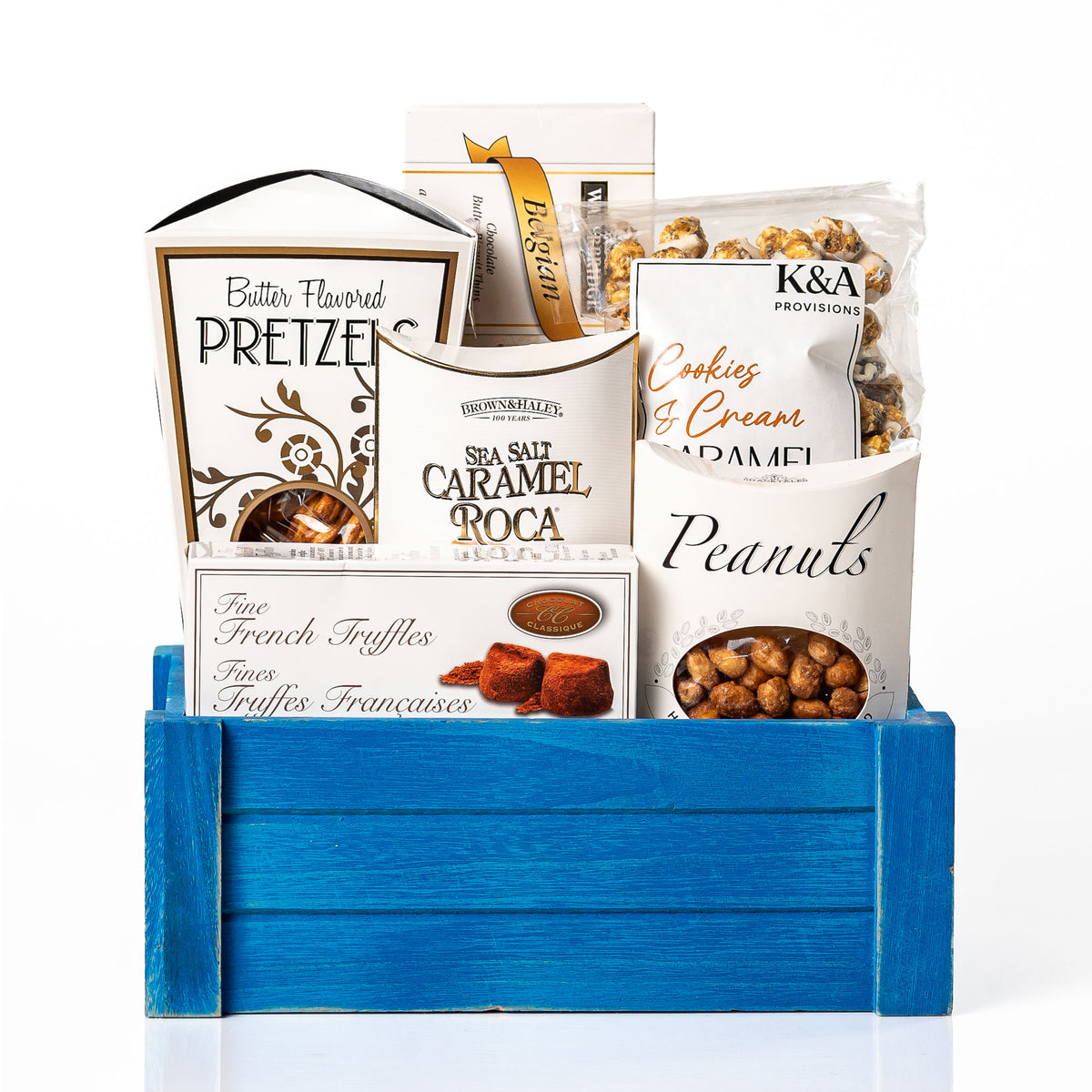 Bites of Bliss gift crate: a blue slotted wood crate with butter pretzels, sea salt caramel roca, French truffles, honey roasted peanuts and cookies and cream caramel popcorn