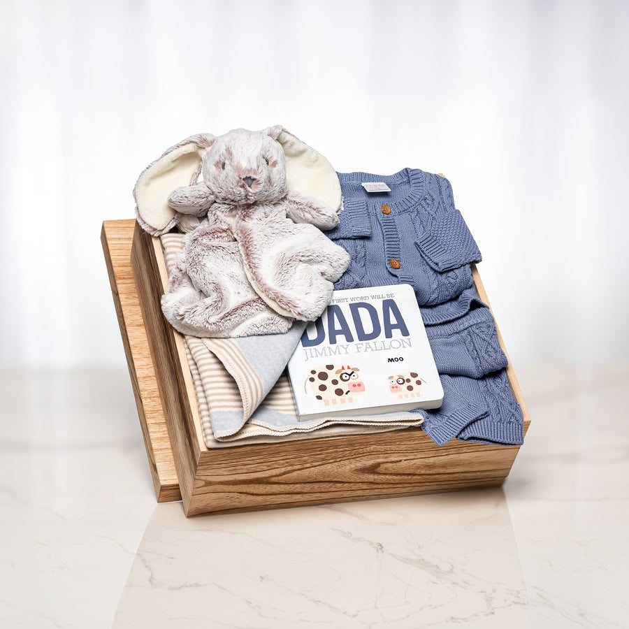Blissful Bunny baby boy gift with a blue knitted set, a plush elephant and the book Dada