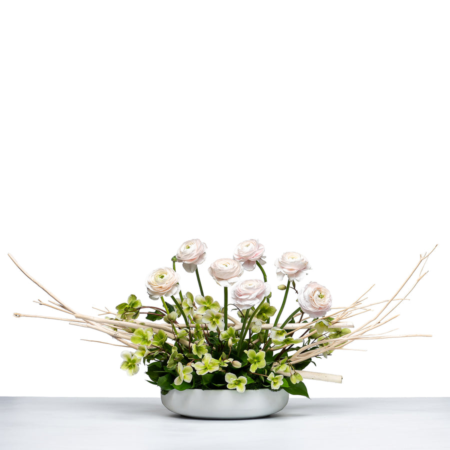 Blossom Beauty arrangement of blush ranunculus and greenery with willow in a white bowl