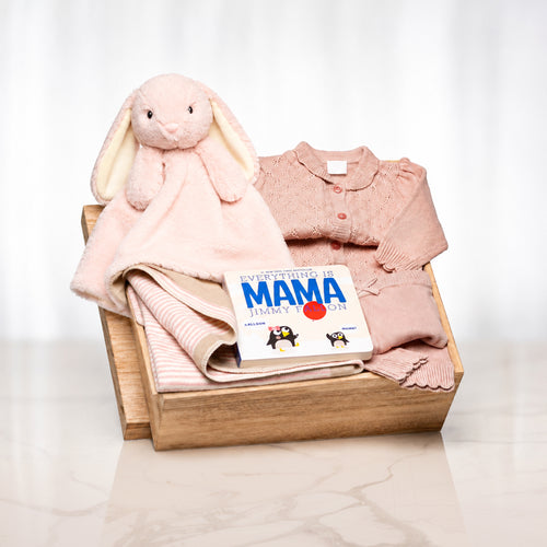 Blushing Bunny baby girl gift with a pink knitted set, a plush bunny comforter and the book Mama