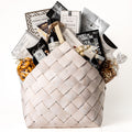 Bountiful Bundle Large: a white washed woven carrier with a bottle of red wine, Castello brie, grissini, crackers, cookie crisps, biscotti and gourmet snacks