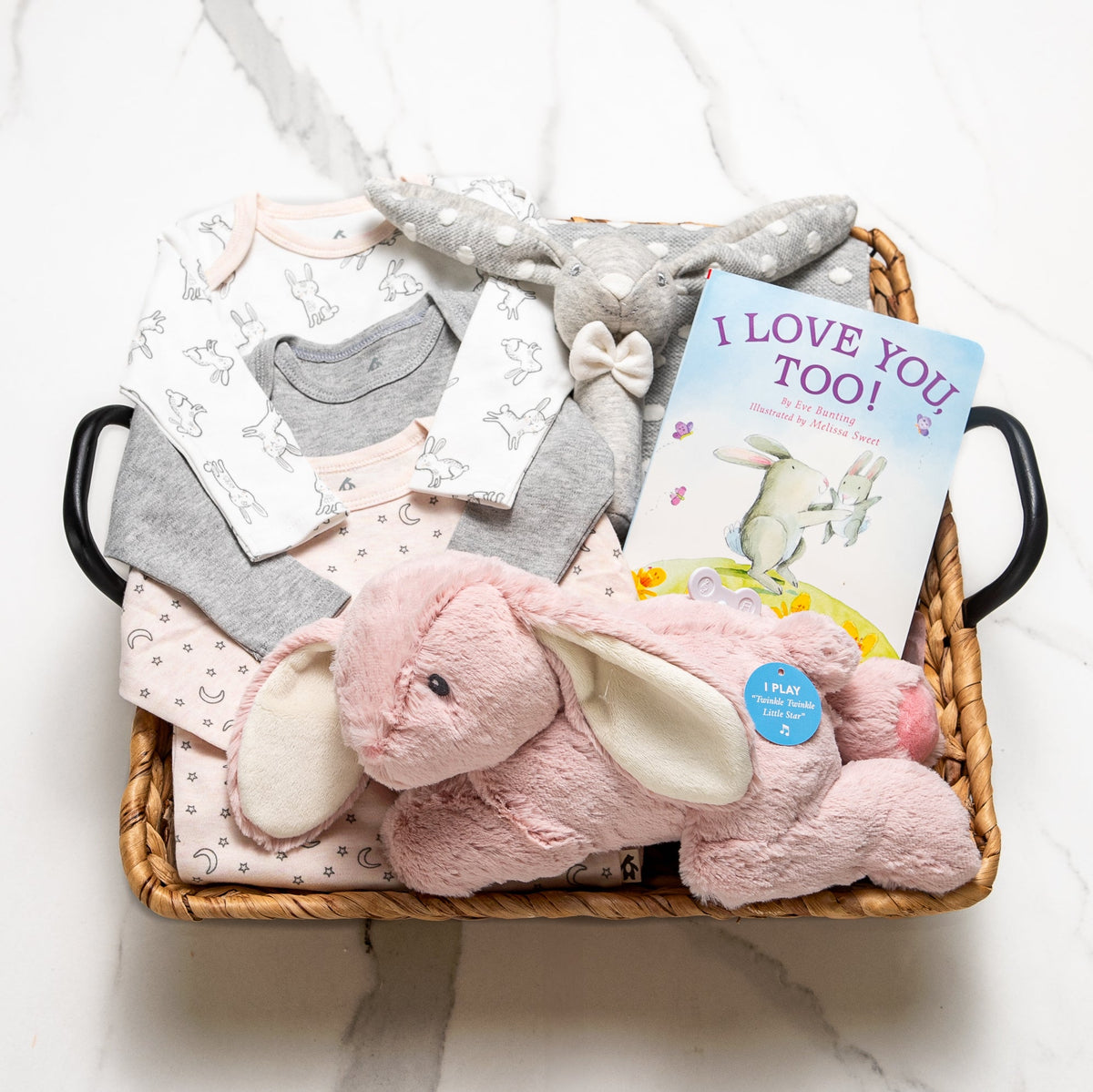 Bunny Bundle baby girl gift basket with onesies, a pink plush bunny and the book I Love You Too