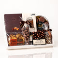 Cocoa gift: a white wood base filled with Bliss hazelnut florentines, chocolate coffee beans, Esta truffles, chocolate covered Oreos, a Donini chocolate bar and chocolate bark
