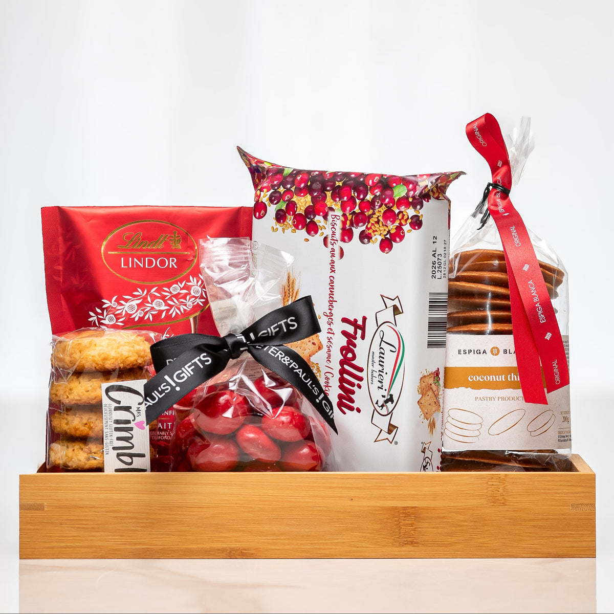 Decadent Delights wooden tray with Lindor chocolate, truffles, cookies and red wrapped treats