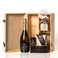 Congratulations Box: a hinged wooden celebration box with dividers holding a bottle of That's Amore Cuvée Spumante, Castello brie, tapenade, water crackers and caramel cashew popcorn