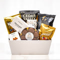 Crafted Cravings large white tub with Cedar Valley crackers, Hardbite chips, truffles and nuts