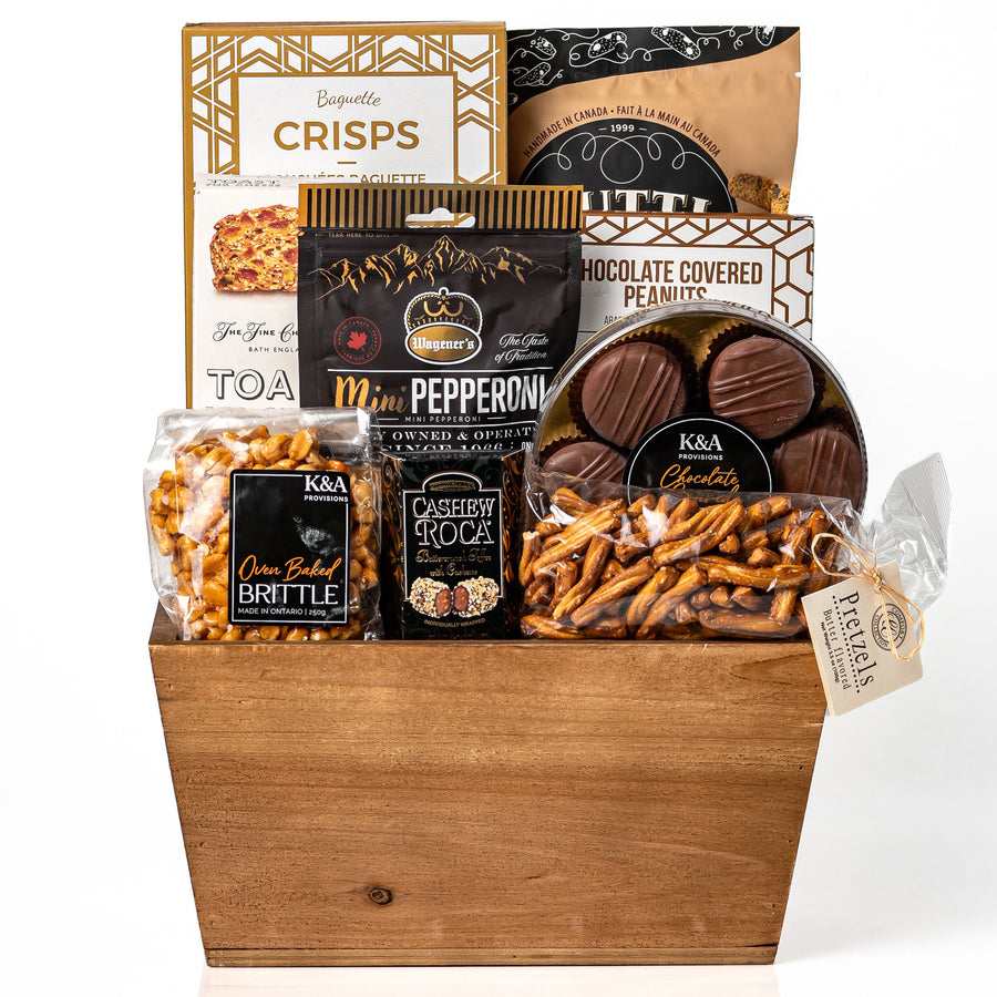 Cravings gift: a wood tapered market tray with baguette crisps, mini pepperoni, chocolate covered peanuts, cashew roca, oven baked brittle, pretzels and chocolate covered Oreos