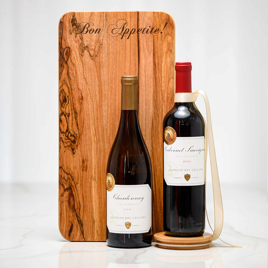 Footed Board gift, an engraved olive wood serving board with a bottle of Chardonnay and a bottle of red wine