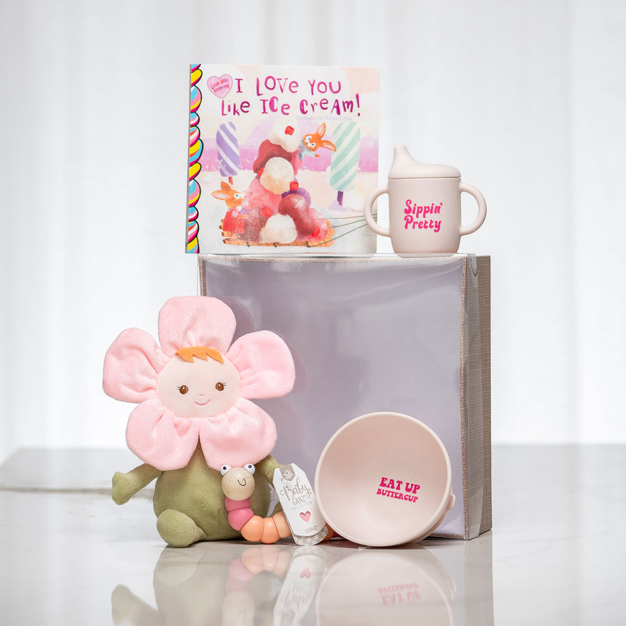 Flower Power baby gift with a flower shaped plush doll, a board book, a mug and a pink bowl