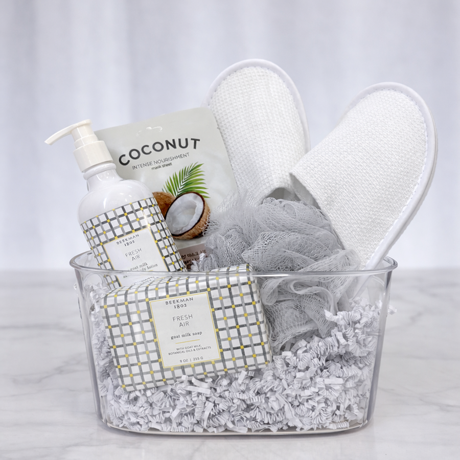 Fresh Favourites spa gift in a clear tub with coconut hand wash, a loofah, slippers and a towel