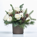 Frost and Fir holiday arrangement of white roses, pine and pine cones in a grey pot