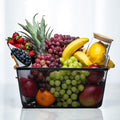 Small fresh fruit basket with pineapple, grapes, bananas, berries and citrus in a black wire basket