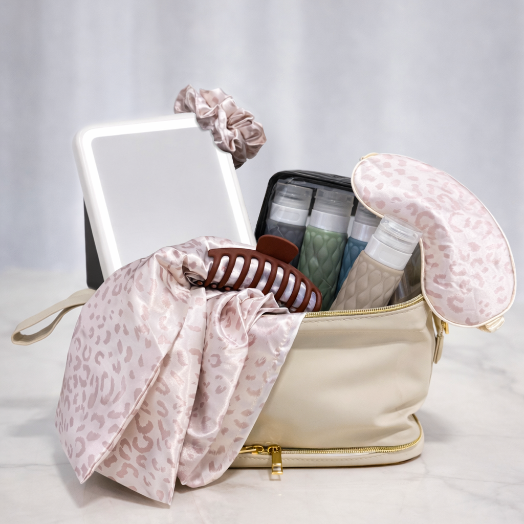 Girl On The Go gift with a cream toiletry bag, a mirror, scrunchies, clips and travel bottles