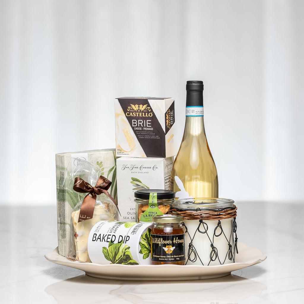 Golden Graze gift board with brie, crackers, baked dip, preserves and a bottle of white wine