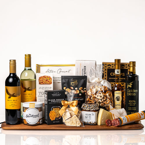 Grand Gourmet gift: a long acacia board with Wolf Blass red and white wine, Golden Bless olive oil, white balsamic, chorizo, Parmigiano, crackers, fig jam and cookies