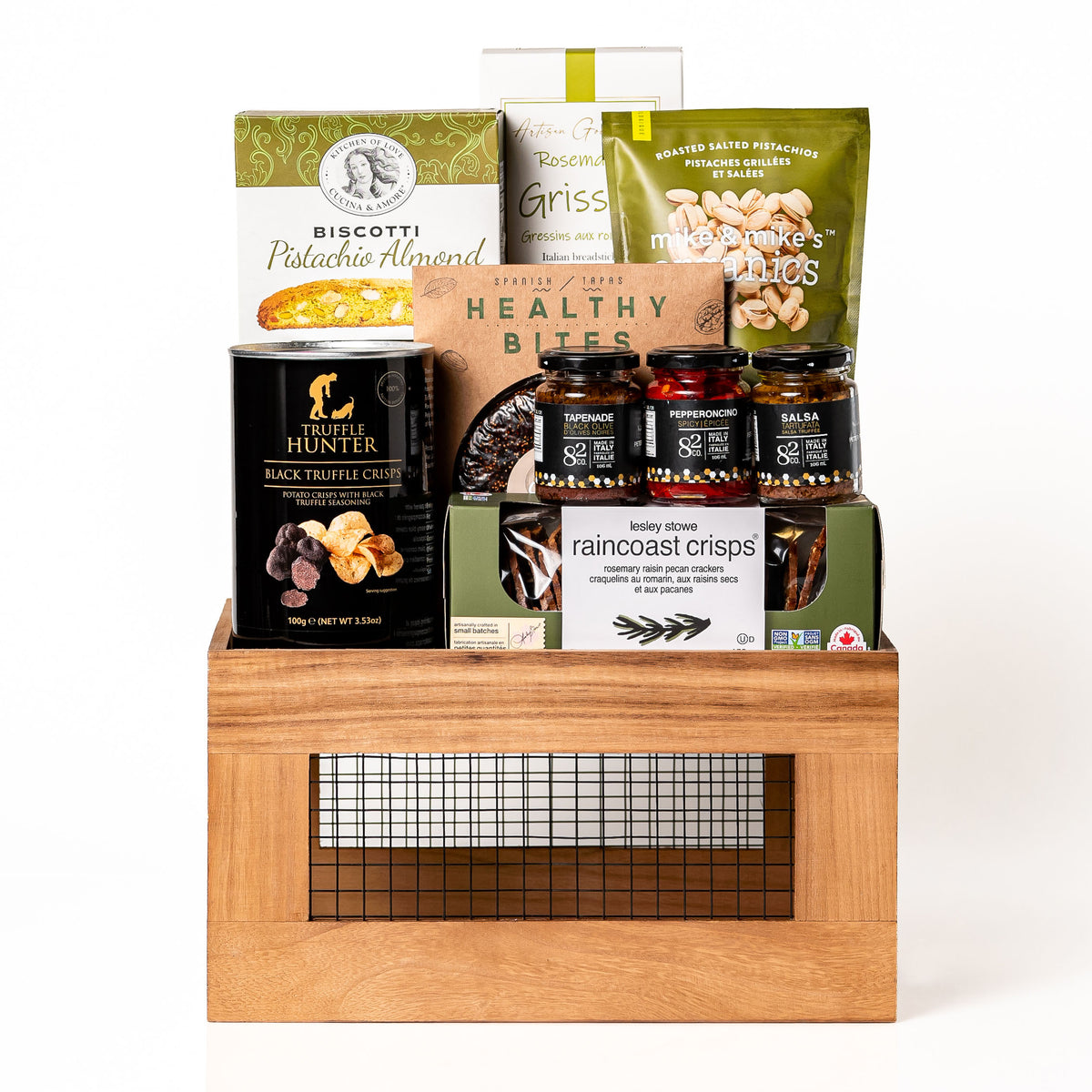 Harvestwood Large: a brown wood crate with a wire mesh front holding black truffle crisps, Co. 82 jars, Raincoast Crisps, a Healthy Bites fig and almond cake, biscotti and pistachios