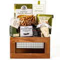 Harvestwood Small: a brown wood crate with a wire mesh front holding pistachio almond biscotti, rosemary grissini, Raincoast Crisps, twisted pretzels, tapenade and pistachios