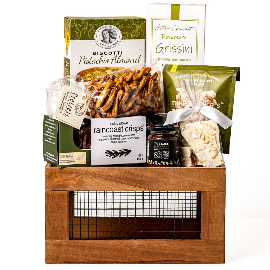 Harvestwood Small: a brown wood crate with a wire mesh front holding pistachio almond biscotti, rosemary grissini, Raincoast Crisps, twisted pretzels, tapenade and pistachios