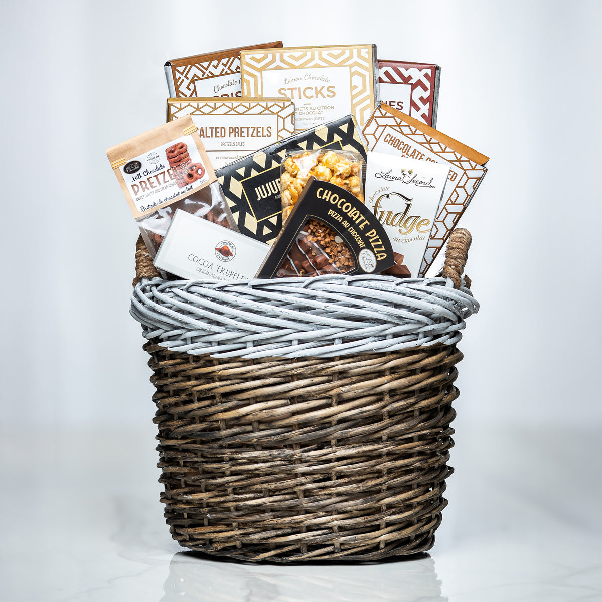 Hearty Hamper small woven basket with charcuterie sticks, pretzels, cookies and chocolates