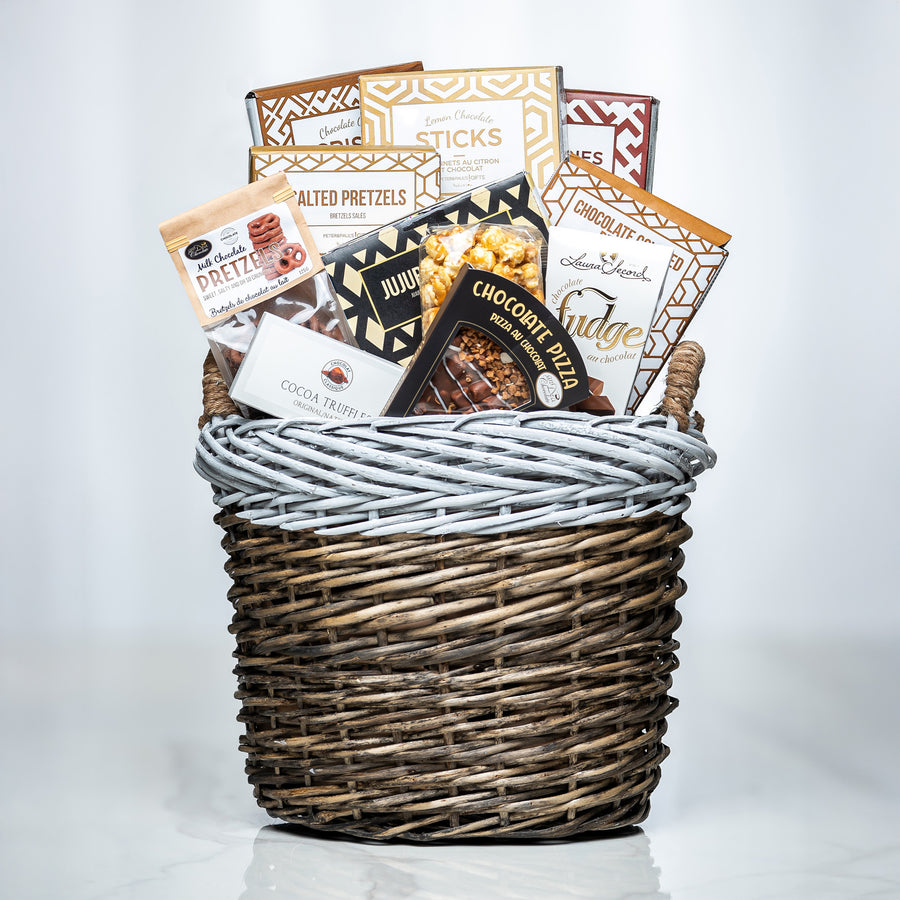 Hearty Hamper small woven basket with charcuterie sticks, pretzels, cookies and chocolates