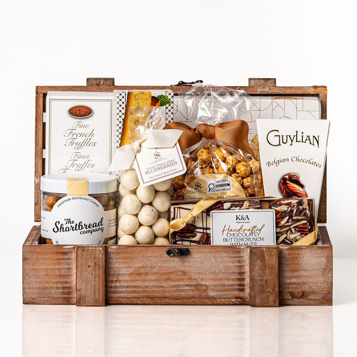 Heritage Small: a wooden crate with Guylian Belgian chocolates, fine French truffles, a jar of shortbread, yogurt covered blueberries, caramel popcorn and buttercrunch
