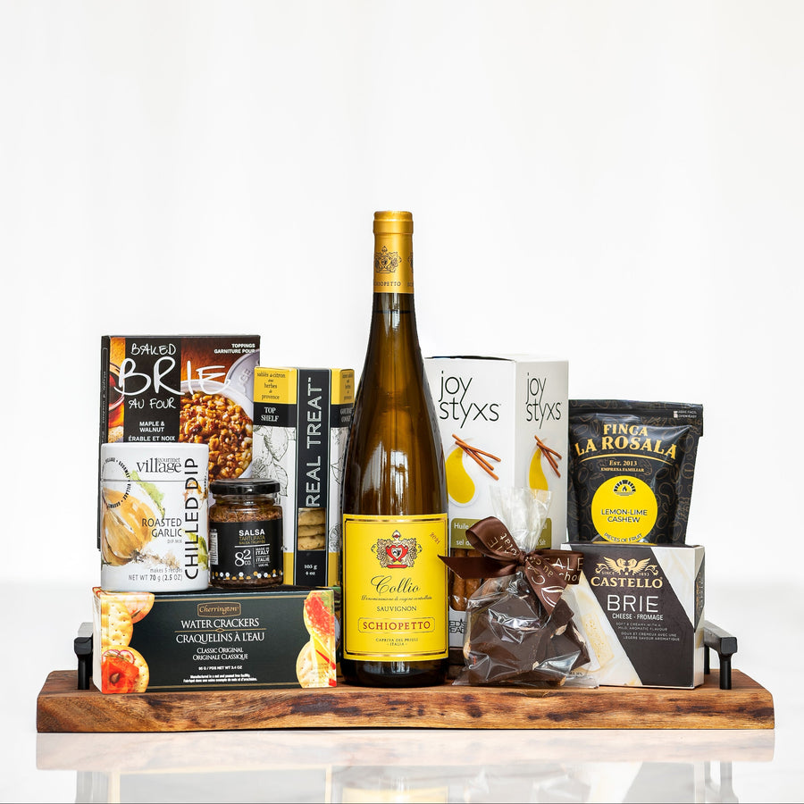Hostess gift board with brie, nuts, crackers, chocolates and a bottle of white wine