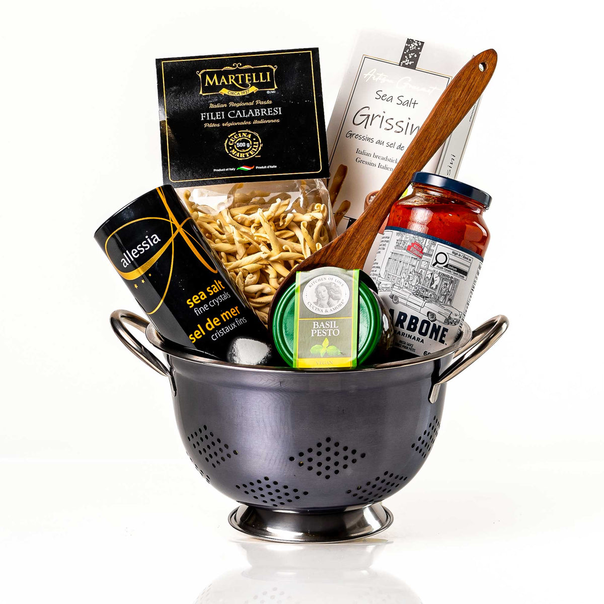 Kosher Kolander gift in a steel colander with pasta, sauce, grissini, olive oil and a wooden spoon