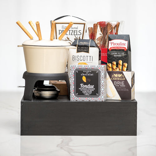 Melting Moments gift with a fondue set, pretzels, biscotti, brie and chocolate on a black riser