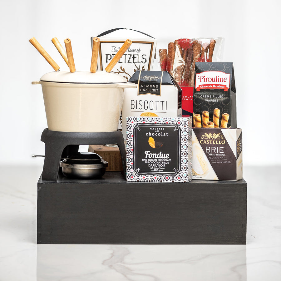 Melting Moments gift with a fondue set, pretzels, biscotti, brie and chocolate on a black riser