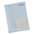 Blue knitted baby blanket with cream polka dots, personalised with the embroidered name John