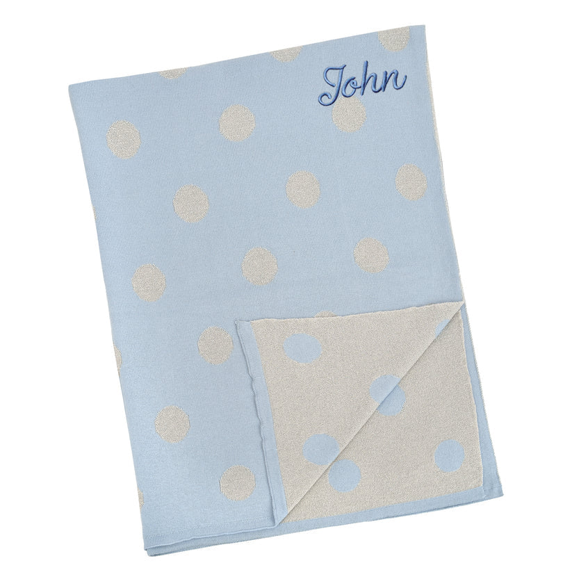 Blue knitted baby blanket with cream polka dots, personalised with the embroidered name John
