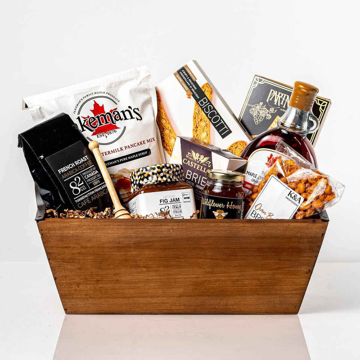 Morning Spread: a wood tapered tray with Jakeman's buttermilk pancake mix, pure maple syrup, Co. 82 French roast coffee, wildflower honey with a wooden dipper, fig jam, Castello brie and biscotti