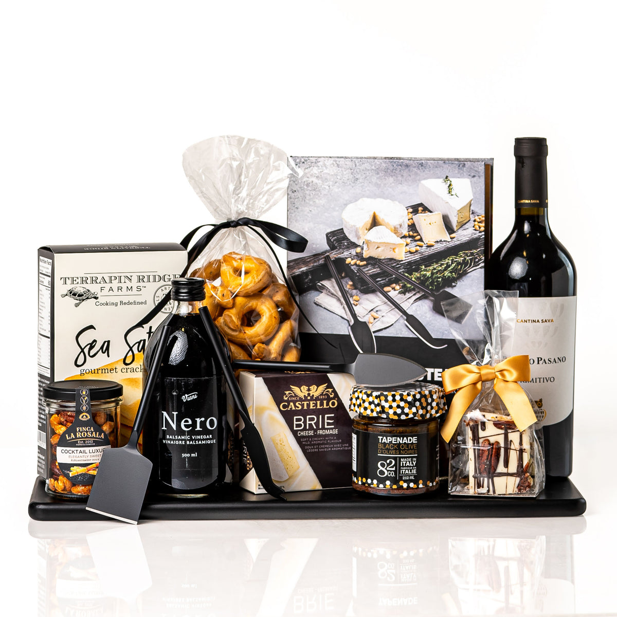 Nero gift: a black serving board with a bottle of Poggio Pasano Primitivo, Nero balsamic vinegar, Castello brie, Terrapin Ridge crackers, cocktail nuts, tapenade and black cheese knives