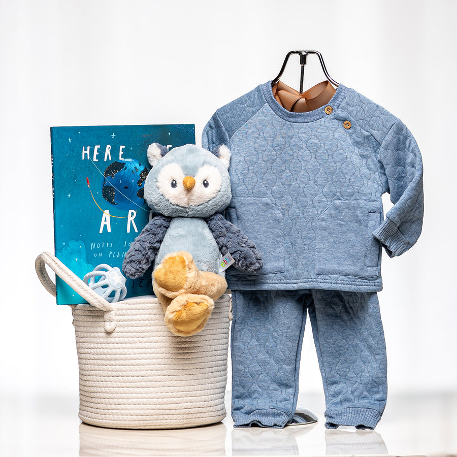 Night Owl baby gift basket with a blue knitted set, a plush owl and a children's book