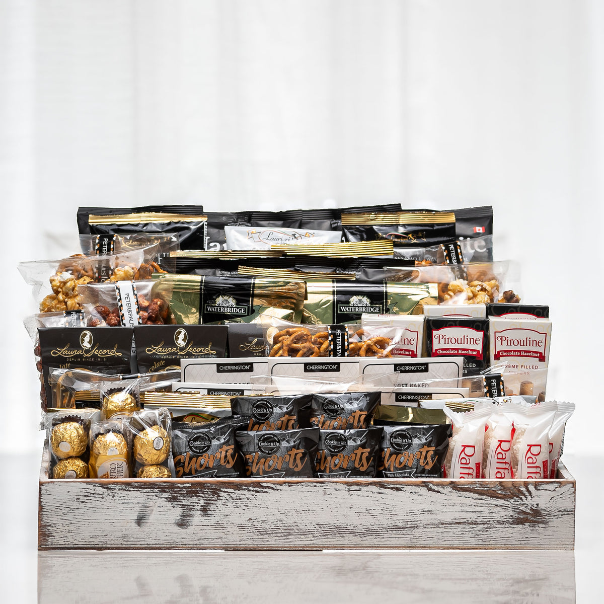 One For All large gourmet gift basket, a tiered wooden crate of chocolates, nuts, cookies and snacks