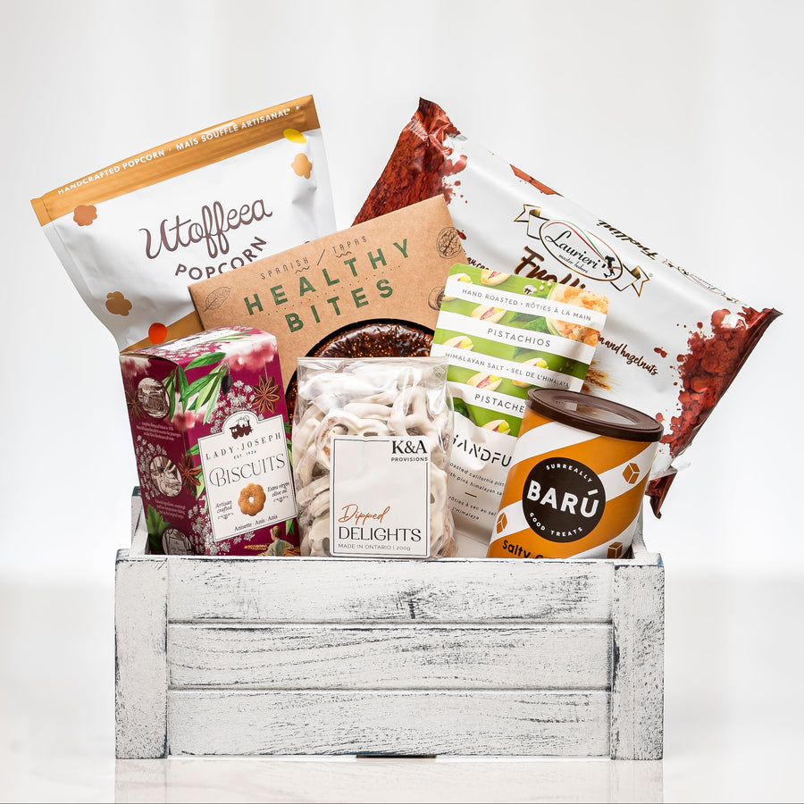 Pantry Pleasures white crate with popcorn, healthy bites, dried fruit and chocolate