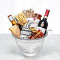 Pasta Pomodoro gift in a white colander with dried pasta, sauces, breadsticks and a striped tea towel