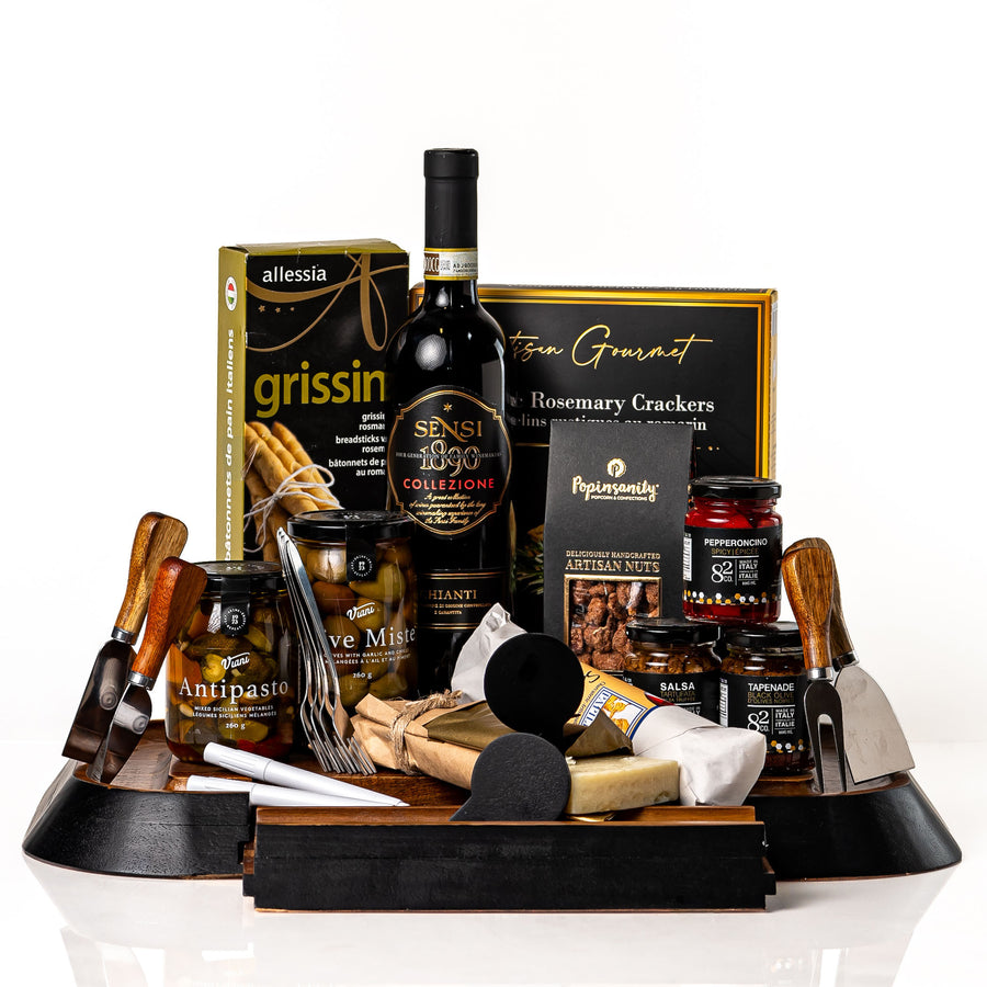 Perfect Pairing: an acacia serving board with a drawer of cheese knives, forks and chalkboard signs, with a bottle of Sensi Chianti, grissini, antipasto, olives, Parmigiano, chorizo and Co. 82 jars