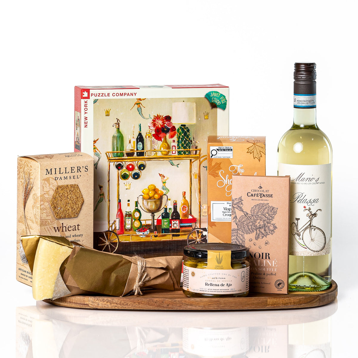 Piece by Piece: an oval acacia wood tray with a 500 piece puzzle, a bottle of white wine, Miller's Damsel wheat crackers, a Parmigiano wedge, stuffed olives, maple shortbread and a Café-Tasse chocolate bar