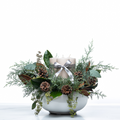 Pillar and Pine holiday centrepiece with a silver ribboned pillar candle, pine cones and magnolia